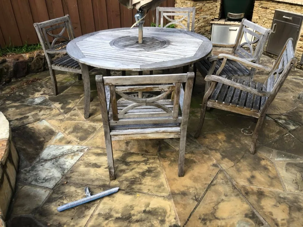 Weathered gray teak patio table and chairs before cleaning