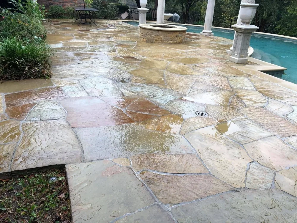 Freshly cleaned flagstone pool patio after pressure washing