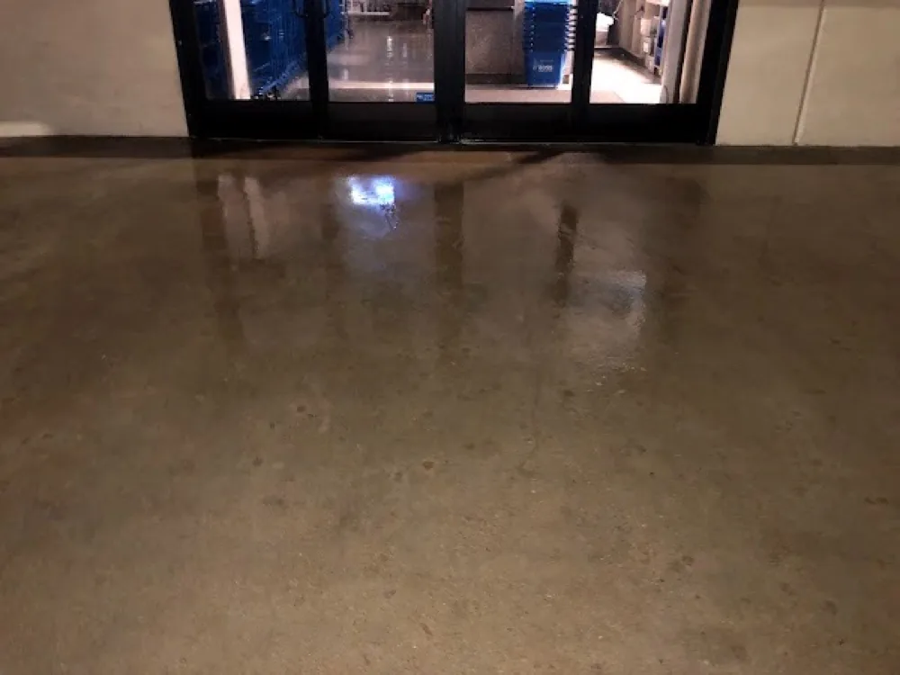 Storefront entrance concrete clean and wet after pressure washing